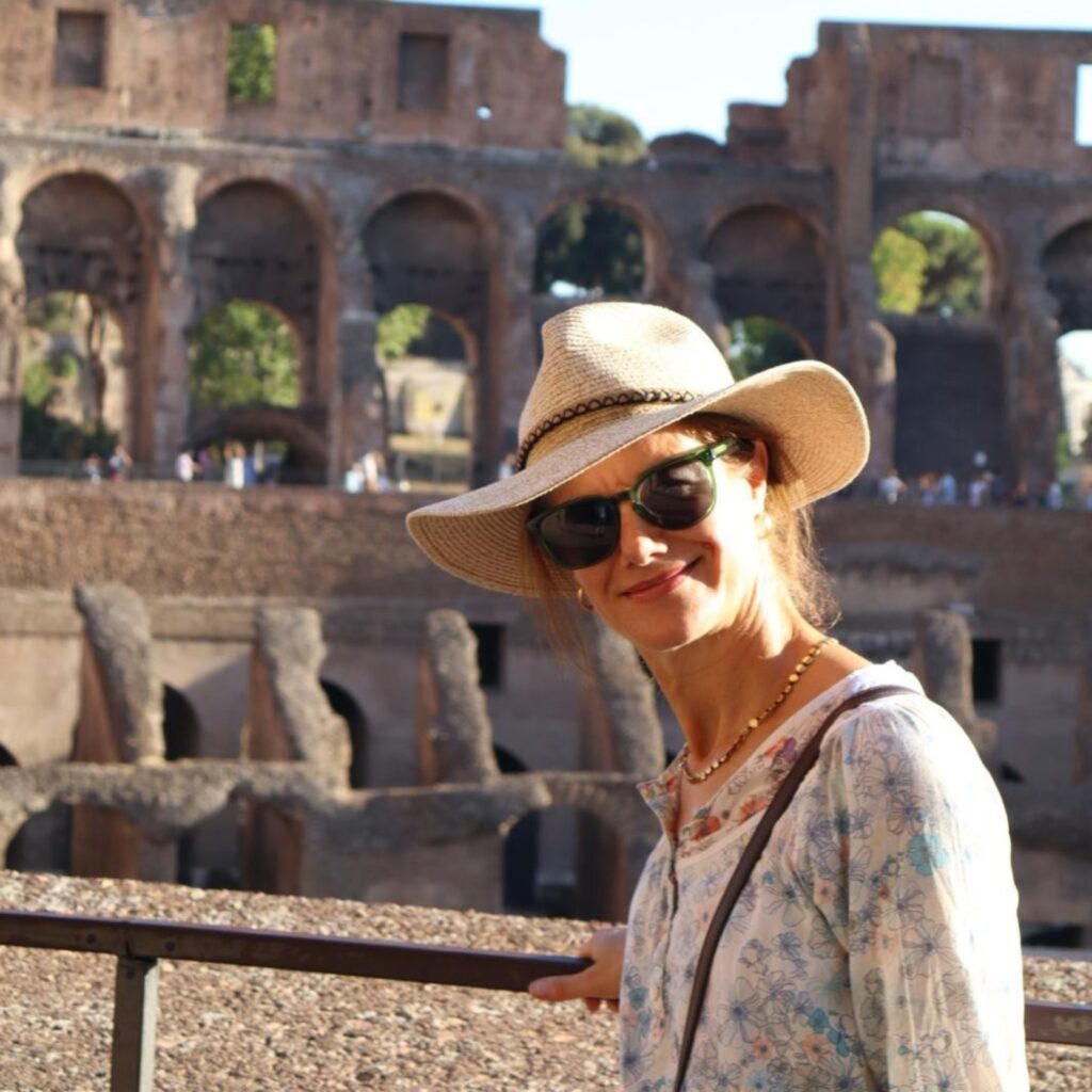 Tourist in sun hat inside the Colosseum in Rome